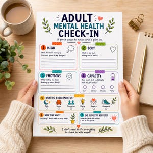 May include: A white paper sheet titled Adult Mental Health Check-In with sections for Mind, Body, Emotions, and Capacity. It includes numbered prompts, icons like a battery and heart, and the text: I don't need to fix everything to check in with myself.