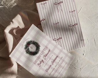 May include: Two rectangular paper cards. One card features a light pink and white buffalo check pattern with a green wreath graphic and text reading MERRY LITTLE Baby Shower in honor of mama-to-be Olivia Johnson. The other card has red stripes and bows.