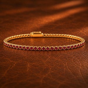 May include: A gold tennis bracelet featuring a continuous row of round, bezel-set red gemstones. The bracelet is constructed with a series of circular gold settings, each holding a single red stone, and includes a rectangular gold clasp mechanism.