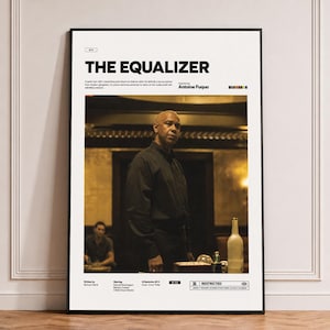 May include: A framed movie poster for The Equalizer, featuring a central image of a person in a black shirt. The white poster includes the title, director Antoine Fuqua, cast names, release date, and a Restricted rating symbol at the bottom.