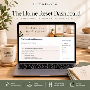 May include: A laptop displaying The Home Reset Dashboard with text reading Put the kettle on. Sort the week out. The screen shows a welcome message, quick links, and task lists. A mug labeled Kettle & Calendar sits beside the laptop on a wooden desk.