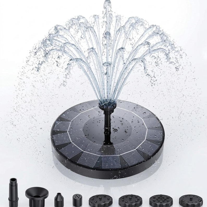 Solar fountain pump for bird bath with floating solar water pump and 6 interchangeable fountain nozzles creating a decorative garden water feature. Solar bird bath fountain adds moving water to bird baths, small ponds, outdoor fountains, and backyard gardens while attracting birds, hummingbirds, butterflies, and pollinators. Eco-friendly solar pond pump operates in direct sunlight for patios, landscaping, wildlife gardens, outdoor décor, and peaceful water fountain displays.