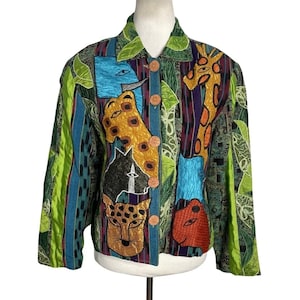 May include: A long-sleeve button-down jacket featuring a vibrant, multi-colored patchwork design with appliquéd animal faces including a giraffe, leopard, and elephant. The garment incorporates various textures, green leaf patterns, and striped panels.