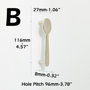 May include: A silver-toned metal cabinet handle labeled B, featuring a spoon-shaped design. Dimensions include a 1.06-inch width, 4.57-inch total length, 0.32-inch base width, and a 3.78-inch hole pitch, clearly marked with technical measurements.