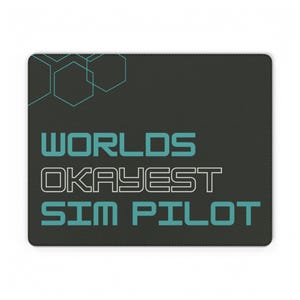 May include: A rectangular black mouse pad featuring a teal and white graphic design. The top left corner displays thin teal hexagonal outlines. The text reads "WORLDS" in teal, "OKAYEST" in white, and "SIM PILOT" in teal, all in a bold font.