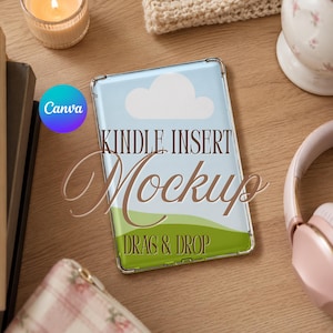 May include: A rectangular Kindle insert mockup featuring a light blue sky with a white cloud and a green grassy hill. The text "KINDLE INSERT Mockup" and "DRAG & DROP" is printed in brown over the landscape design on the clear plastic case.