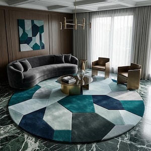 May include: A large circular area rug featuring a geometric pattern of interlocking polygons in shades of teal, navy blue, light blue, and gray. The rug has a soft, plush texture and covers a significant portion of the floor space in the room.