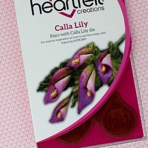 May include: A package of three heart felt creations Calla Lily die cuts. The package is pink and white with a picture of the die cuts on the front. The die cuts are a set of three Calla Lily flowers.