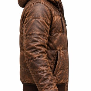 May include: A brown hooded jacket with a distressed leather-like texture and horizontal quilted stitching. The jacket features a front zipper closure, a dark brown ribbed knit hem and cuffs, and side pockets, captured from a side profile view.
