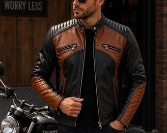 May include: A black and brown leather jacket featuring a mandarin collar with a snap button, quilted shoulder panels, and silver-toned metal zippers on the chest and front closure. The design incorporates contrasting color-blocked leather panels.