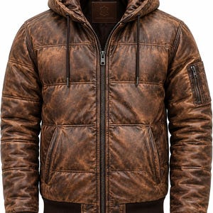 May include: A brown leather jacket with a quilted texture, a hood with drawstrings, and a full-length front zipper. The jacket features a ribbed hem and cuffs, two side pockets, and a small zippered utility pocket on the upper left sleeve.
