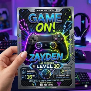 May include: A rectangular gaming-themed birthday invitation card featuring a black game controller graphic, neon blue and green text reading GAME ON! and ZAYDEN HAS REACHED LEVEL 10, with event details for Saturday August 16th at 245 Greenhill Road.