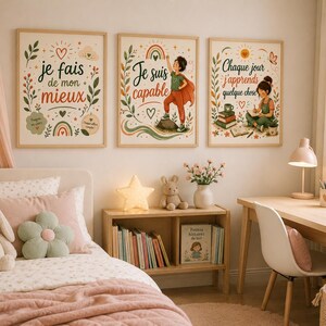 May include: Three rectangular wall art prints featuring illustrations and French text. The left print says 'je fais de mon mieux', the centre print says 'Je suis capable' with a child in a cape, and the right print says 'Chaque jour j'apprends quelque chose'.