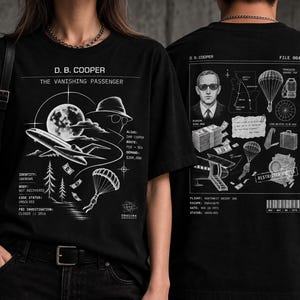 May include: A black t-shirt featuring white graphic prints on the front and back. The front displays D.B. Cooper, a plane, a parachute, and case details. The back shows a portrait, a map, money, and technical flight data labeled File 004.