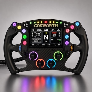 May include: A black carbon fiber racing steering wheel featuring a central digital display with the text COSWORTH. The wheel includes multiple illuminated buttons in purple, blue, green, and red, along with four rotary dials and a coiled cable.