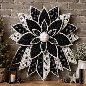 May include: A large, star-shaped fabric wall hanging featuring layered, pointed petals in black and white. The black petals have a subtle glitter finish, while the white petals display a pattern of snowflakes and holly leaves. A white quilted center.