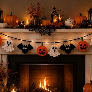 May include: A Halloween garland featuring crocheted figures of orange jack-o'-lanterns, white ghosts, and black bats strung along a black cord. The garland is illuminated by small warm white lights and hangs horizontally across a fireplace mantel.