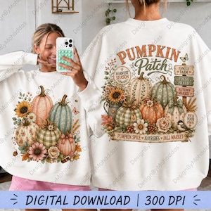Op de afbeelding: Een wit sweatshirt met lange mouwen en een grafische print van pompoenen, zonnebloemen en herfstbladeren. Het ontwerp bevat de tekst "PUMPKIN Patch" en "HARVEST SEASON", samen met bordjes met "FAMILY FARM", "FRESH PICKED" en "AUTUMN MARKET".