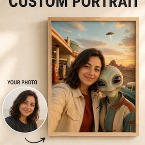 May include: A framed custom portrait featuring a person and an alien standing together in front of a retro gas station at sunset with a flying saucer in the sky. The text CUSTOM PORTRAIT appears at the top and YOUR PHOTO is near a circular inset.