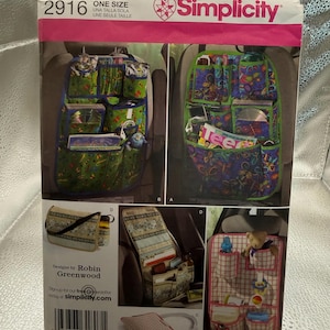 May include: A Simplicity sewing pattern envelope 2916 for car seat organizers. The front displays four variations of organizers with multiple pockets in green, purple, and plaid fabrics, featuring designs by Robin Greenwood with text and a barcode.