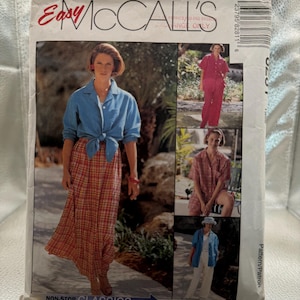 May include: A McCall's sewing pattern envelope titled Easy McCall's Non-Stop Classics Petite-Able Select-A-Size. The front features photographs of clothing including a blue button-down shirt, a plaid skirt, red pants, and a matching red shirt set.