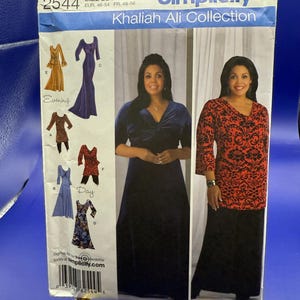 May include: Simplicity sewing pattern 2544 from the Khaliah Ali Collection, size BB 20W-28W. The envelope features illustrations of various dress and top designs, including a navy velvet gown and a red and black patterned top with a black skirt.