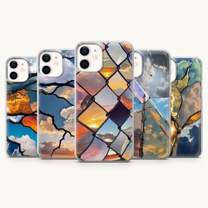 May include: Five clear smartphone cases featuring various sky-themed designs. The designs include silhouettes of tree branches against sunset clouds, a chain-link fence overlaying a golden sunset, and a utility pole against a cloudy blue sky.