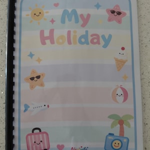 May include: A spiral-bound notebook with a pastel striped cover featuring the text My Holiday. The cover includes cartoon illustrations of a sun, starfish, ice cream, aeroplane, beach ball, suitcase, palm tree, and camera with smiling faces.