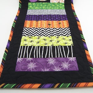 Halloween Table Runner, Quilted Table Topper with Spiders in Black, White, Orange, Green and Purple