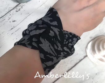 Wide bracelet wrist cover in black, dark colour jewellery office wear,