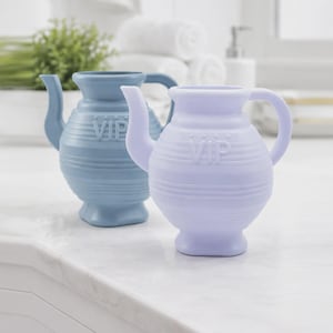 May include: Two small, rounded pitchers with handles and spouts, one in light blue and one in light purple. Each pitcher features horizontal ribbed detailing around the body and the letters VIP embossed in a raised font on the front center.
