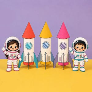 May include: Two cartoon astronaut figures and three paper rockets standing in a row. The astronauts wear white suits with pink or teal accents. The rockets have white bodies with red, yellow, or pink conical tops and matching base fins.