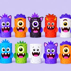May include: A collection of ten cylindrical paper monster crafts arranged in two rows. Each monster features a unique color, including purple, orange, black, red, white, blue, and green, with distinct facial expressions, horns, and small arms.