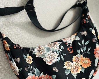 Crescent black floral cross body bag