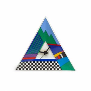 May include: A triangular wall clock featuring a geometric pattern with sections of blue, green, purple, red, yellow, and a black and white checkered border. The clock has three black hands positioned in the center of a white triangular cutout.