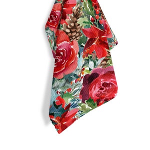 May include: A red and green floral kitchen towel with a watercolor design of roses, pine cones, and berries.