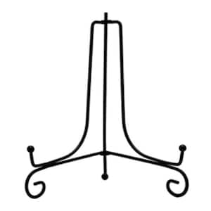May include: Black metal display stand with a curved base and a single upright post. The stand is designed to hold plates, platters, or other decorative items.