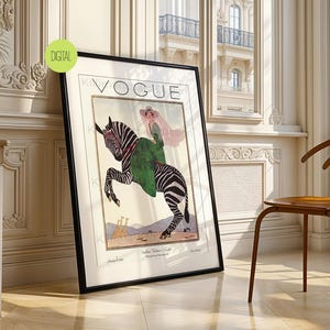 May include: A framed wall art print featuring a vintage Vogue magazine cover illustration. The artwork depicts a person in a green dress and wide-brimmed hat riding a zebra, with two giraffes in the background. The text VOGUE is printed at the top.