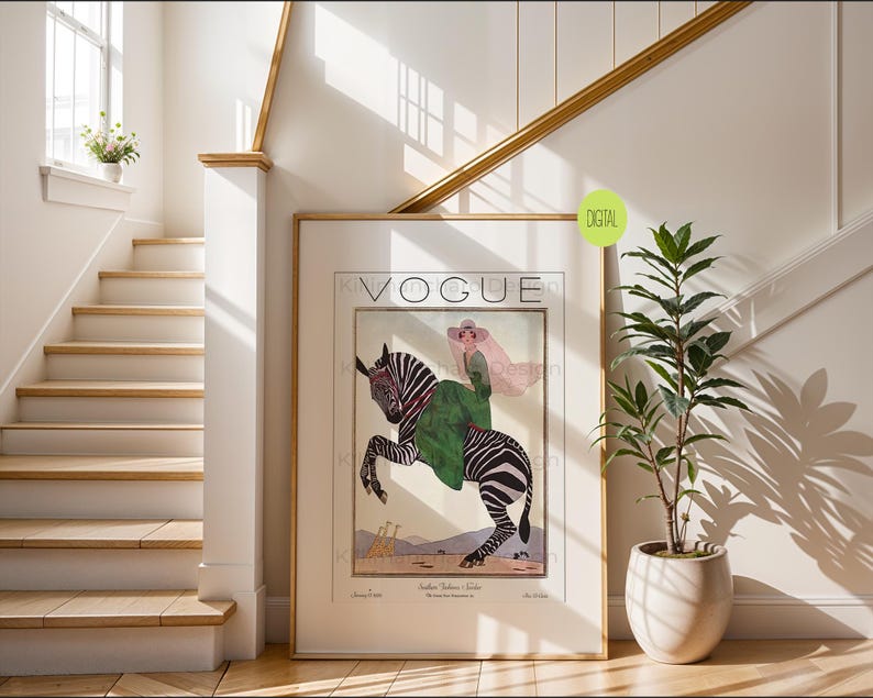May include: A framed wall art print featuring a vintage-style Vogue magazine cover illustration. The artwork depicts a person in a green dress and wide-brimmed hat riding a zebra, with two giraffes in the background. The text reads Vogue.