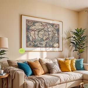 May include: A large framed vintage map print with a gold frame hangs above a beige sectional sofa with colourful throw pillows. A potted plant and a lamp with a beige shade are on a wooden side table. The room has a neutral colour palette.