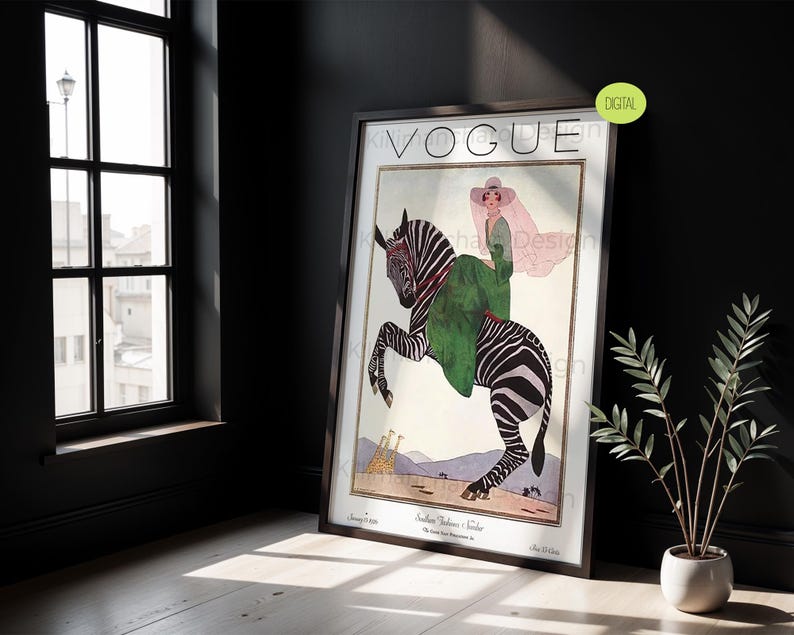 May include: A framed wall art print featuring a vintage Vogue magazine cover illustration. The artwork depicts a person in a green dress and wide-brimmed hat riding a zebra. The background shows a desert landscape with giraffes and the text VOGUE.