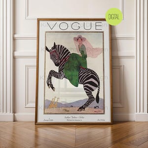 May include: A framed vintage Vogue magazine cover print featuring an illustration of a person in a green dress and wide-brimmed hat riding a zebra. The background shows a desert landscape with two giraffes. The text reads Vogue and January 15 1920.