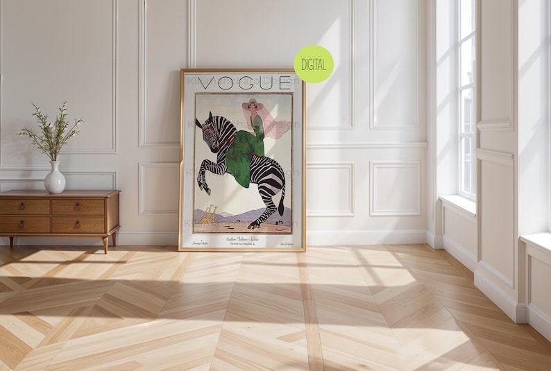 May include: A framed Vogue magazine cover print featuring an illustration of a person in a pink hat and green coat riding a zebra. The artwork includes the text VOGUE at the top and smaller text at the bottom, with a green circular DIGITAL label.