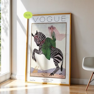 May include: A framed vintage Vogue magazine cover print featuring an illustration of a person in a green dress and wide-brimmed hat riding a zebra. The artwork includes two giraffes in the background, the text VOGUE, and the date January 15 1926.