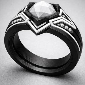 May include: A black ring with a faceted white centre stone and white geometric accents along the band, featuring small embedded clear stones. The text Level 2 Ring Coming Soon! is displayed in red at the top of the image.