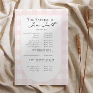 May include: A rectangular baptism programme card featuring a light pink and white gingham border and a central white arch containing black text. The text reads The Baptism of Jane Smith, 3rd June 2026, followed by a list of ceremony participants.