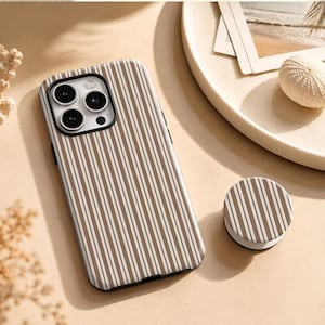 May include: A smartphone case and a matching circular collapsible phone grip featuring a vertical striped pattern in shades of brown and white. The case has a black camera module cutout with three circular lenses and a flash, designed for a modern device.
