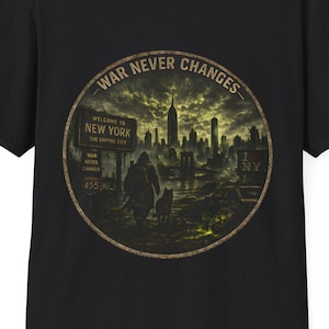 May include: A black short-sleeve t-shirt featuring a circular graphic print. The design depicts a post-apocalyptic New York City skyline with a figure and dog in the foreground. The text reads WAR NEVER CHANGES, WELCOME TO NEW YORK, and I NY.