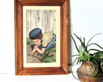 Vintage Aquarell mit einem Jungen mit einem blauen Hut, der Murmeln spielt, betitelt ""A real concentration"" von Blanche Ferguson."