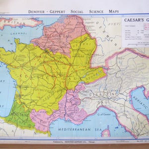 May include: A Denoyer-Geppert Social Science map titled Caesar's Gaul, featuring color-coded regions of ancient Europe including Britain, Belgian Gaul, Celtic Gaul, and Cisalpine Gaul, with red lines indicating military campaigns and a legend.